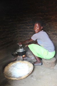 Fainess, one of our sponsored students, cooking in her family's kitchen