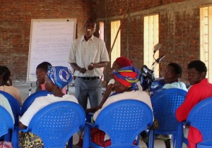 Yohane leading a training session for guardians of families overloaded with orphans