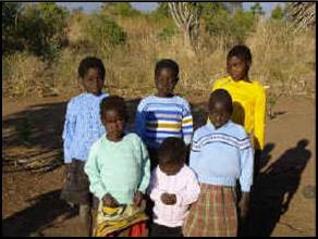 Six of the twelve orphans in the first family to be registered with Kindle.  Their grandmother had died, leaving them an orphan-headed household. They are shown wearing one of Kindle’s first donations – sweaters made and sent by a lady in Australia.